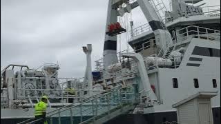 Ship Spotting Crane lifting a pallet with gasoline onboard the ship.