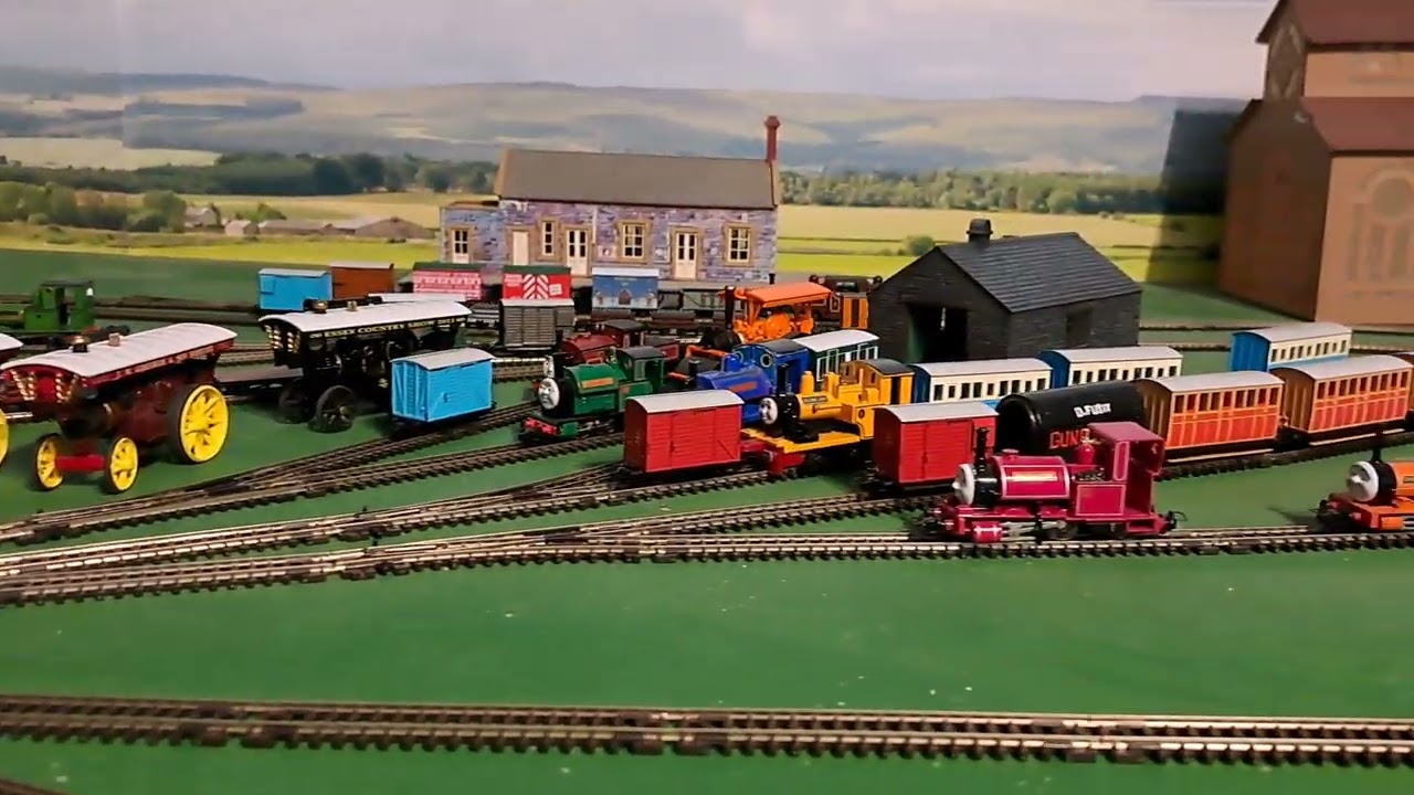 Bachmann Rusty pulling 4 Brown 4 grey slate wagons and blue brakvan 