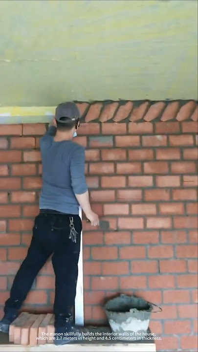 A mason builds interior walls of a house