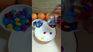 REVERSE A VERY COLORFUL CHOCOLATE NIPS IN A MICKEY MOUSE PLATE