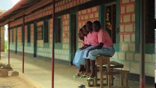 Children sitting on a bench in a village in Kenya.