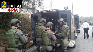 Students held at school while police search for 6 gunmen