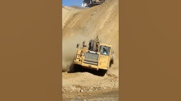 Thumbnail of CAT 657G scraper storming down a steep hill! #shorts #shortsfeed