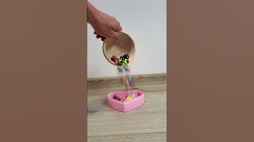 dice falling from a wooden bowl into a pink heart #reverse