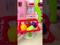 Miniature kitchen washing and blender mix strawberry grape orange smoothies