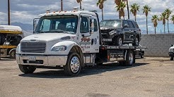 Towing Wrecked Car On A Flatbed