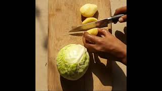 Chopping vegetables to make cabbage potato and pea simple sabji