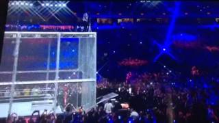 Shane attempts to elbow drop the undertaker through a table