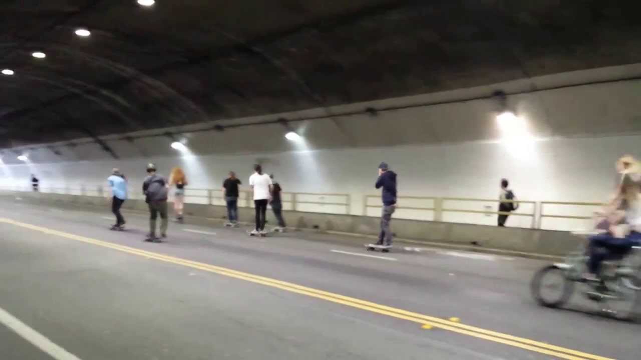 Skateboarders Roll down the Stockton Street tunnel in San Francisco