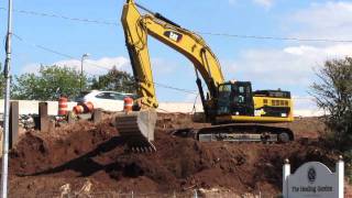 Cat 345DL Excavator loading trucks