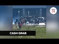 WATCH | Gauteng residents frantically grab cash from van at smouldering CIT heist scene