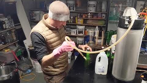 Racking beer off a pressure keg into grolsch bottles.