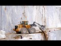Volvo wheel loader working in narrow marble quarry plateau