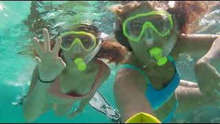 Two Girls Snorkeling Over Shallow Reef