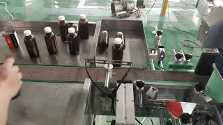 round bottle labeling machine with label presence detection and rejection system