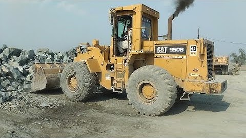 Caterpillar 950B Wheel Loader Loading Huge Rocks On Rock Crusher