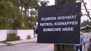 Immigration advocates post signs throughout Lake Worth Beach after recent arrests
