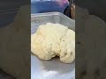A food dough that is being formed by a chef evenly