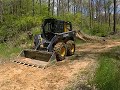 John Deere 326E Doing a Bit of Road Maintenance