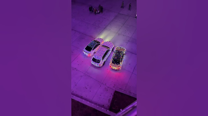 Luxury cars covered in Christmas lights