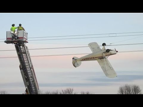 Pilot is rescued after his plane crashes and gets tangled in power lines