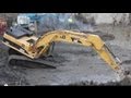 Cat 345CL Excavator digging dirt from around sheeting