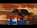 Chainsaw carved bear on a log . Time lapse.