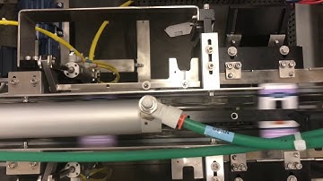 Econocorp Spartan Cartoner Automatically Loading Small Vials of Oil in to a Tuck Style Carton