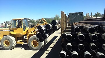 Unloading 7in pipe off a rail car