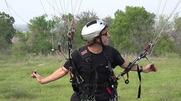 Paraglider wingovers to landing