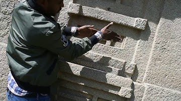 Analyzing the design of the Aksum stele by tour guide Yirga. June 2019.