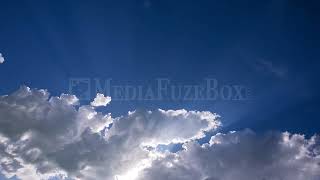 8K Stock Video - Time lapse of clouds moving as sun rays shine through