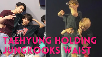 Taehyung holding Jungkook