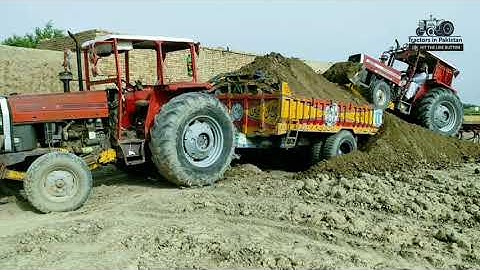 Mf 385 with front blade loading trolley and Mf 375 pulling trolley