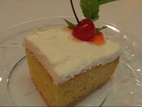 In this video, Betty demonstrates how to make Tres Leches Cake. This is a cake of Mexican origin that translates to "Three Milk Cake." It is beautiful and delicious! Ingredients: 1 stick butter, softened to room temperature 1 cup sugar 5 eggs Â½ teaspoon vanilla extract 1 Â½ cups all-purpose flour 1 Â½ teaspoons baking powder cooking oil spray (for baking dish) 1 cup milk (I used skim milk.) 12-oz. can evaporated milk 14-oz. can sweetened condensed milk 1 Â½ cups whipping cream Â¼ cup confectioner's sugar mint sprigs and stemmed maraschino cherries for garnish In a large mixing bowl, beat Â½ cup butter and 1 cup sugar until light and fluffy. Add 5 eggs and Â½ teaspoon vanilla, and beat until well combined. In a medium mixing bowl, combine 1 Â½ cups all-purpose flour with 1 Â½ teaspoons baking powder. Gradually add flour mixture to butter and egg mixture, stirring continually until all of the flour mixture is incorporated into the butter and egg mixture. Pour batter into a 13-inch by 9-inch by 2-inch baking dish that has been sprayed with cooking oil spray. Bake at 350 degrees (F) until a toothpick inserted in the center comes out clean. The baking time may vary from 20 to 30 minutes, depending on your oven. Remove cake from oven and use a fork to pierce the cake all over. Set cake aside. In a medium mixing bowl, stir together1 cup milk, a 12-oz. can of evaporated milk, and a 14-oz. can of sweetened condensed milk. Pour the milk mixture over the top of the cake, covering it <b>...</b>