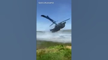 military helicopter sideways over water