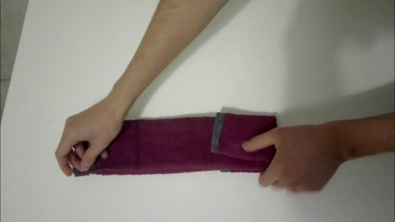 How to roll a towel for packing (step-by-step).