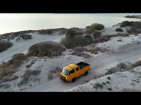Preview of the yellow 1990 Syncro Doka on the sand at Playa Tecolote