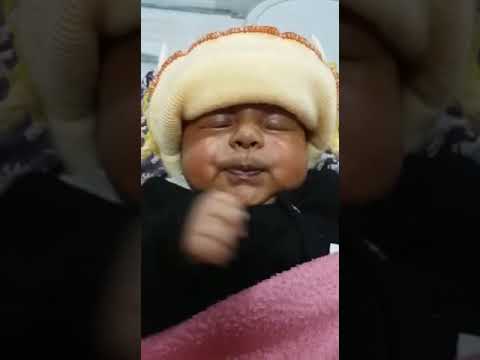 funny-baby-videos-sleeping-with-a-very-cute-smile-and-funny-face