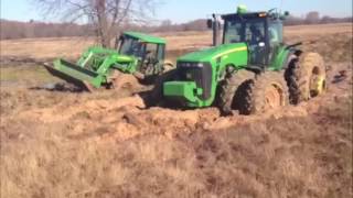 2 John Deere tractors stuck in the mud