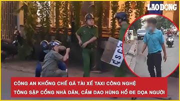 Công an khống chế gã tài xế taxi công nghệ tông sập cổng nhà dân, cầm dao hùng hổ đe dọa người