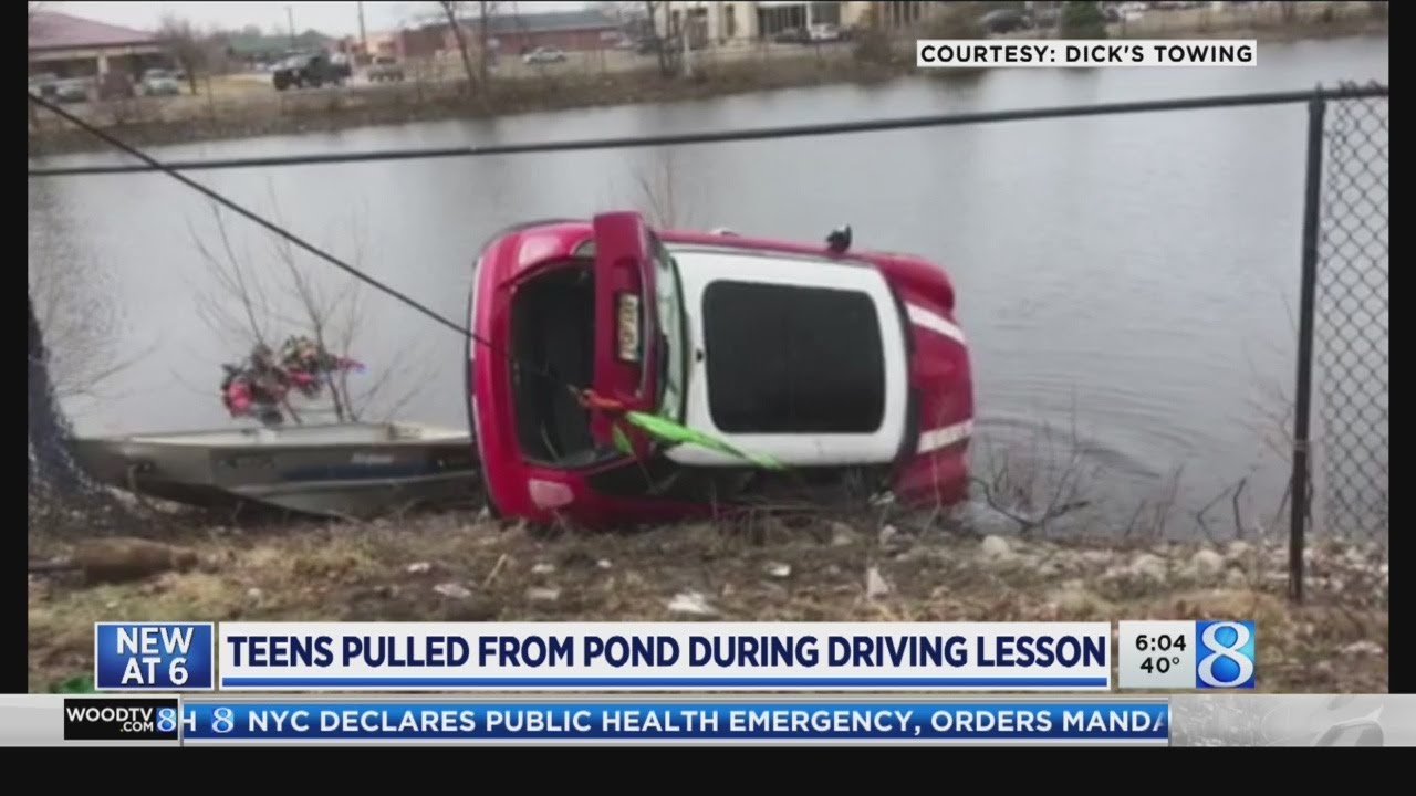 Teens escape after car crashes into pond - YouTube