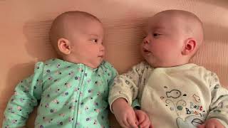 Adorable Twins Staring at Each Other and Holding Hands