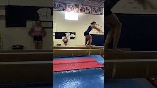 Split jump, standing layout on beam