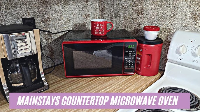 Mainstays 0.7 Cu ft Compact Countertop Microwave Oven, Red