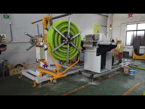 Double wall hose coiling and strapping machine