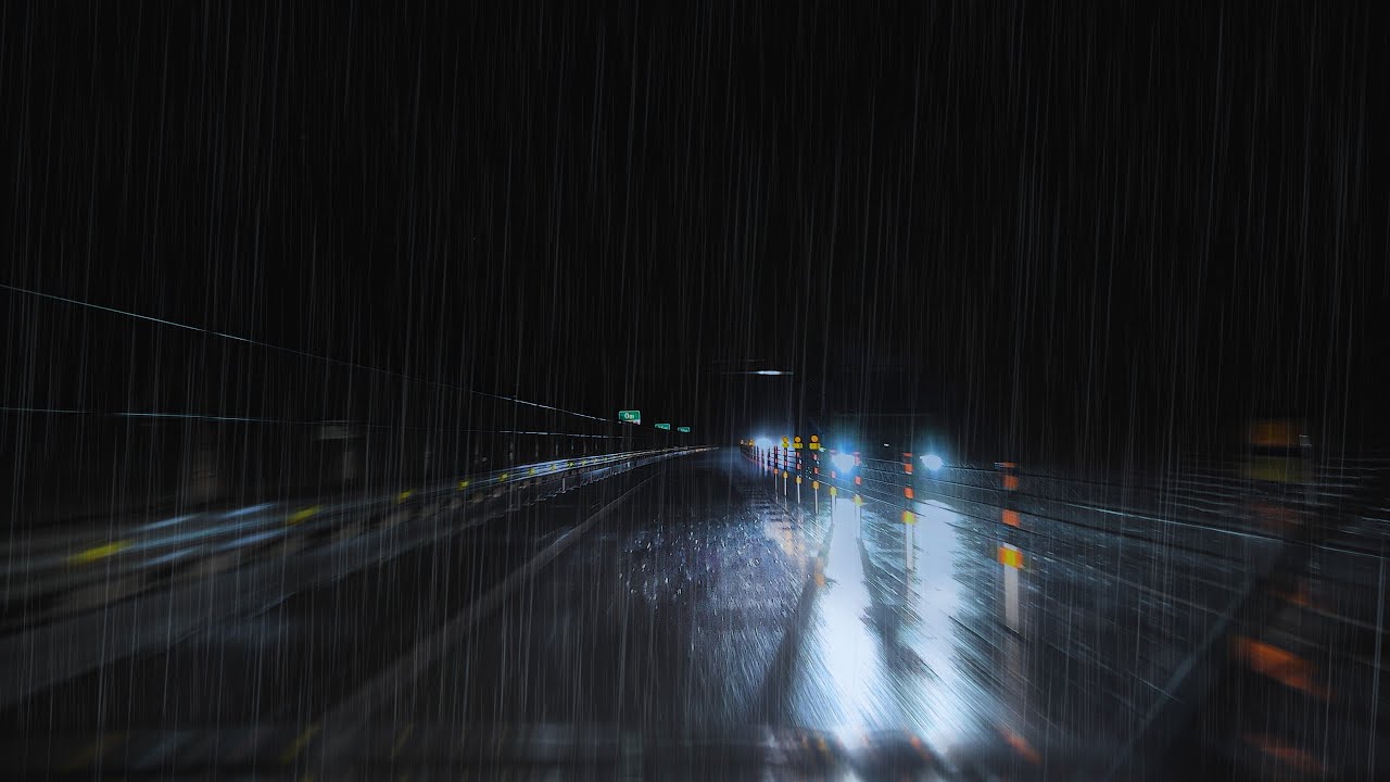 Lonely midnight drive on rainy highway