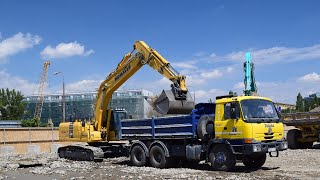 KOMATSU PC240LC crawler excavator  loading TATRA truck on construction site