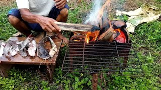 cutting/cooking and eating delicious grilled catfish