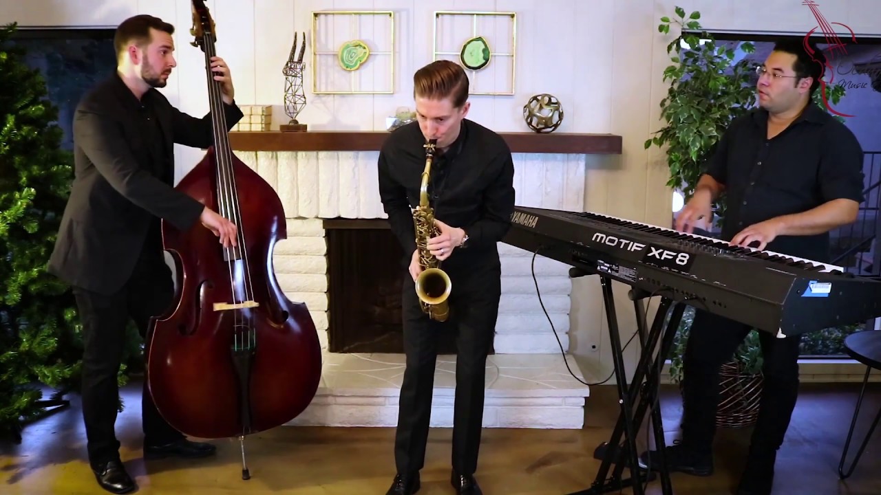 Wedding jazz trio performing At Last with saxophone, keys and bass